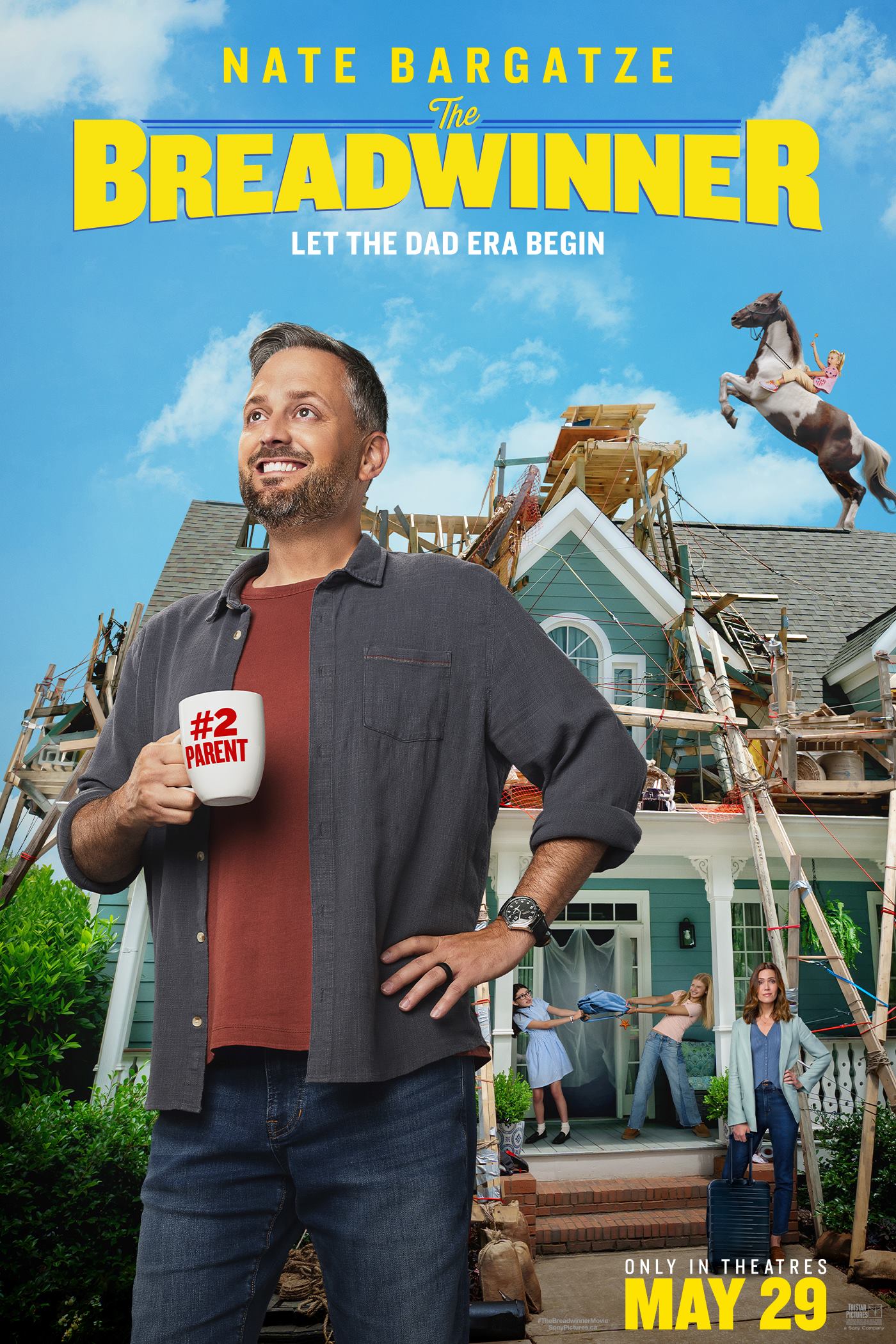Nate Bargatze posing with a mug that says "#2 Parent" in front of a chaotic home.